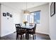 Cozy dining area with a modern chandelier and a view of the neighborhood at 5630 W 11Th Pl, Lakewood, CO 80214