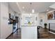Spacious kitchen with stainless steel appliances, an island with a breakfast bar, wood floors, and ample cabinet space at 5630 W 11Th Pl, Lakewood, CO 80214