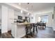 Contemporary kitchen featuring a center island with bar seating and stainless appliances, with open flow to the dining area at 5630 W 11Th Pl, Lakewood, CO 80214
