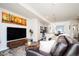 Cozy living room with comfortable leather sofa, entertainment center, area rug, and open access to the modern kitchen at 5630 W 11Th Pl, Lakewood, CO 80214