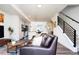 Inviting living room boasts an open floor plan, modern kitchen, staircase, and plenty of natural light at 5630 W 11Th Pl, Lakewood, CO 80214