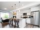 Bright, modern living space with open kitchen, bar seating, stainless appliances, and hardwood floors at 5630 W 11Th Pl, Lakewood, CO 80214