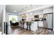 Bright, modern living space with open kitchen, bar seating, stainless appliances, and hardwood floors at 5630 W 11Th Pl, Lakewood, CO 80214