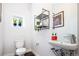 Clean and modern powder room with a unique sink, shelving, and a small window at 5630 W 11Th Pl, Lakewood, CO 80214