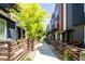 Street view of modern townhomes with balconies and fenced front yards at 5630 W 11Th Pl, Lakewood, CO 80214