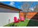 Private backyard featuring artificial turf and two bright red Adirondack chairs at 2600 S Adams St, Denver, CO 80210