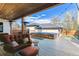 Outdoor backyard featuring a deck with an outdoor lounge area, a hot tub, and lush landscaping at 2600 S Adams St, Denver, CO 80210