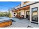 Backyard patio featuring comfortable lounge seating, a fireplace, mounted television, and a luxurious hot tub at 2600 S Adams St, Denver, CO 80210