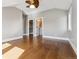 Open bedroom with hardwood floors and access to a walk-in closet and an updated bathroom at 2600 S Adams St, Denver, CO 80210