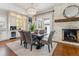 Dining room with a stone fireplace, chandelier, dining table, and built-in cabinetry at 2600 S Adams St, Denver, CO 80210