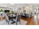 Open dining area with views of the kitchen and staircase, featuring a large dining table with seating for six at 2600 S Adams St, Denver, CO 80210