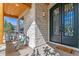 Charming front porch with stone columns, wood ceiling, rocking chairs, and an ornate front door at 2600 S Adams St, Denver, CO 80210