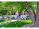 Charming front porch with stone pillars, manicured lawn, and a sidewalk leading to the entryway at 2600 S Adams St, Denver, CO 80210