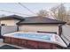 Inviting hot tub with clear water, set on a deck with overhead string lights, creating a cozy and relaxing outdoor space at 2600 S Adams St, Denver, CO 80210