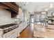Open kitchen featuring stainless steel appliances, gas range, granite countertops, and custom cabinetry at 2600 S Adams St, Denver, CO 80210