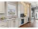 Kitchen features a wine refrigerator, built-in coffee maker, custom cabinets, and stone countertops at 2600 S Adams St, Denver, CO 80210