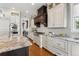 Chef's kitchen features custom cabinetry, granite counters, stainless steel appliances, and a gas cooktop at 2600 S Adams St, Denver, CO 80210