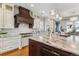 Gourmet kitchen with custom cabinets, granite countertops, a large island, and stainless steel appliances at 2600 S Adams St, Denver, CO 80210