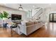 Bright living room with wood floors, stairs, stone fireplace, and stylish furniture at 2600 S Adams St, Denver, CO 80210