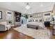 Spacious main bedroom with a fireplace, decorative chandelier, and large windows providing natural light at 2600 S Adams St, Denver, CO 80210