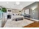 Spacious main bedroom with hardwood floors, chandelier, decorative rug, and a sitting area at 2600 S Adams St, Denver, CO 80210
