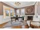 Stylish home office with large windows, a stone fireplace, and wood floors at 2600 S Adams St, Denver, CO 80210