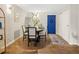 Inviting dining room featuring a modern table setting, hardwood floors, and a bright blue door at 2 N Adams St # 108, Denver, CO 80206
