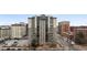 Exterior view of high-rise condo building, featuring parking and a nearby city street at 2 N Adams St # 108, Denver, CO 80206