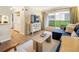Well-lit living room with a blue sectional, entertainment center, and access to a charming balcony at 2 N Adams St # 108, Denver, CO 80206