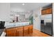 Open-concept kitchen with granite countertops, wood cabinetry, and stainless steel appliances at 437 S Reed Ct, Lakewood, CO 80226