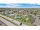 A community aerial view featuring a pool, tennis court, and proximity to the highway at 8378 S Upham Way # B305, Littleton, CO 80128