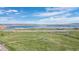 Scenic aerial view of a park featuring a lake and highway under a sunny sky at 8378 S Upham Way # B305, Littleton, CO 80128