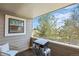 Relaxing balcony with seating and grill offers outdoor living with peaceful views of the surrounding landscape at 8378 S Upham Way # B305, Littleton, CO 80128