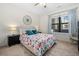 Bedroom with floral bedding, two side tables, and large window at 8378 S Upham Way # B305, Littleton, CO 80128