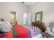 Well-lit bedroom featuring a view into the ensuite bathroom, comfortable bed, and stylish decor at 8378 S Upham Way # B305, Littleton, CO 80128