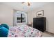 Tranquil bedroom with floral bedding, large window, dark wood dresser, and ceiling fan creating a relaxing ambiance at 8378 S Upham Way # B305, Littleton, CO 80128