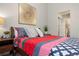 Cozy bedroom with natural light, colorful bedding, side tables, and decor creating a warm and inviting space at 8378 S Upham Way # B305, Littleton, CO 80128