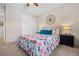 Comfortable bedroom featuring a floral comforter, bedside tables, and ample closet space providing a serene atmosphere at 8378 S Upham Way # B305, Littleton, CO 80128