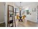 Bright dining area with modern light fixture and view of the kitchen at 8378 S Upham Way # B305, Littleton, CO 80128