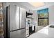 Kitchen features stainless steel appliances, white cabinets, and a window view at 8378 S Upham Way # B305, Littleton, CO 80128