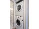 Laundry closet with stacked washer and dryer at 8378 S Upham Way # B305, Littleton, CO 80128