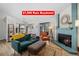Cozy living room featuring a unique fireplace, comfortable seating, and lots of natural light at 8378 S Upham Way # B305, Littleton, CO 80128