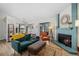 Bright living room featuring a blue fireplace, hardwood floors, and open access to the kitchen at 8378 S Upham Way # B305, Littleton, CO 80128