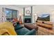 Inviting living room with fireplace, comfortable seating, and balcony access offering natural light and a relaxing ambiance at 8378 S Upham Way # B305, Littleton, CO 80128