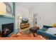 Living room with fireplace, TV, and view into the doorway of a bathroom at 8378 S Upham Way # B305, Littleton, CO 80128