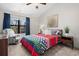 Cozy main bedroom features a colorful quilt, chair, and bright natural light at 8378 S Upham Way # B305, Littleton, CO 80128