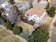 Aerial view of the private backyard with a deck, lush lawn, mature trees, and white fencing at 7858 Oban Ct, Lone Tree, CO 80124