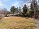 Spacious backyard featuring a terraced retaining wall with mature trees and lovely landscaping at 7858 Oban Ct, Lone Tree, CO 80124