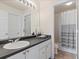 Functional bathroom featuring a vanity sink, mirror, and shower-tub combination, maximizing space and convenience at 7858 Oban Ct, Lone Tree, CO 80124