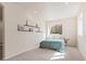 Bright bedroom with neutral decor, a window, and stylish shelving with decorative accents at 7858 Oban Ct, Lone Tree, CO 80124